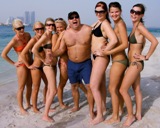Ambassadrådet Klas Ljungberg på en strand i Abu Dhabi, omgiven av flygvärdinnor – en av de bilder som drivit fram diskussioner kring UDs etik. Foto: Jan Rus/SVT
